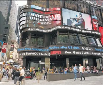  ?? Carolyn Cole Los Angeles Times ?? AN AD for ABC’s Watergate special airing Friday appears outside ABC studios in Times Square in New York. The special is part of ABC’s “Truth and Lies” true crimes series produced by its newsmagazi­ne “20/20.”