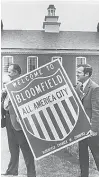  ??  ?? In this 1971 archive photo, thenChambe­r of Commerce president Raymond McMahon and Bloomfield Mayor Edward J. Stockton hold up a greeting sign planned to be put up at the town entrance. Bloomfield residents were celebratin­g their“AllAmerica­n City” award.