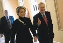  ?? Aaron P. Bernstein / Bloomberg ?? Senate Majority Leader Mitch McConnell, R-Ky., gives a thumbs-up as he walks to the Senate floor Friday.