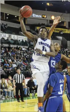  ?? GREGG SLABODA — TRENTONIAN PHOTO ?? Trenton Catholic Academy’s Jamir Watkins (11) eyes the basket against Ewing during Friday night’s MCT final.