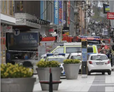  ?? ANDERS WIKLUND — TT NEWS AGENCY (VIA AP) ?? The rear of the beer truck, left, protrudes out of the Stockholm department store that it crashed into, killing four people.