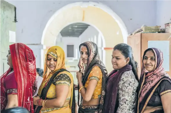  ?? PHOTOGRAPH: AMARJEET KUMAR SINGH/GETTY ?? ▼ Women queue to vote. Micro loans have given many independen­ce, and the right to choose who to vote for