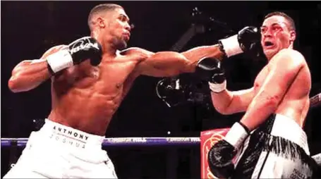  ??  ?? Two- World Champion, Anthony Joshua, delivers a punch at his opponent Joseph Parker in the unificatio­n bout on Saturday night in Cardiff, Wales