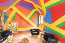  ??  ?? 7#1082: bars of color, 2003, by Sol LeWitt (1928-2007), covers the walls and ceiling of Al Shands’ office. The two Bibendum chairs are by Eileen Gray (1878-1976).8The walls of a bedroom are covered by a wall painting, Forest of Dreams, 2016, by American artist Odili Donald Odita. On the shelf are ceramic works by, from left, Bill Stewart, Wayne Ferguson and Aurore Chabot. On the floor is a wood turned vessel by Edward Moulthrop (1916-2003).9The master bedroom contains a commission­ed installati­on work by Betty Woodman (1930-2018) titled From a Loggia in Tuscany, 1994, plus two carved wood sculptures by folk artist Donny Tolson, Jacob Wrestling the Angel, 1982, at left, and Man and Woman, 1981, to the right.10At the back of the house with Mary Carothers’ sculpture Beneath the Surface, 2016.11Reinstal­ling Richard Long’s sculpture Slate Atlantic, 2002, Delabole slate. It is 420 inches in diameter.