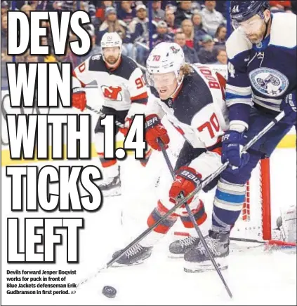  ?? AP ?? Devils forward Jesper Boqvist works for puck in front of Blue Jackets defenseman Erik Gudbranson in first period.