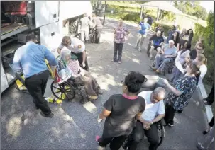  ?? The Associated Press ?? EVACUATION: Staff members at Westwood Nursing and Rehabilita­tion Center in Fort Walton Beach, Fla., and firefighte­rs from Fort Walton Beach Fire Department load Hurricane Irma evacuees, who had stayed at Westwood since last Saturday, onto a bus on...