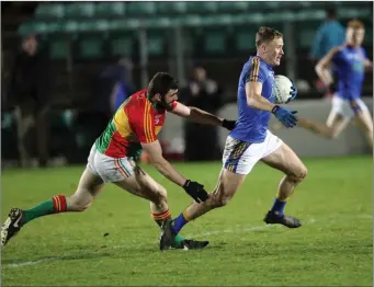  ??  ?? Wicklow’s Dean Healy gets away from Carlow’s Sean Murphy in Netwatch Cullen Park. Photos: Joe Byrne