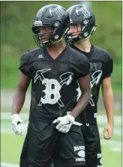  ??  ?? Emanuel Harvey and Hunter Davis wait for a play call.