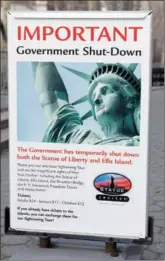  ?? SHANNON STAPLETON / REUTERS ?? A sign announcing the closure of the Statue of Liberty, due to the US federal government shutdown, sits near the ferry dock to the Statue of Liberty at Battery Park in Manhattan of New York City on Sunday.