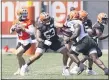  ?? RON SCHWANE — THE ASSOCIATED PRESS ?? Browns center Nick Harris (53) works against defensive tackle Larry Ogunjobi (65) as Baker Mayfield looks to throw during an Aug. 14 practice in Berea.