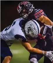  ?? Kevin Karzin/For The Signal ?? Hart’s Michael Colangelo (2) is brought down by Saugus’ Robert Vega after picking up a first down.