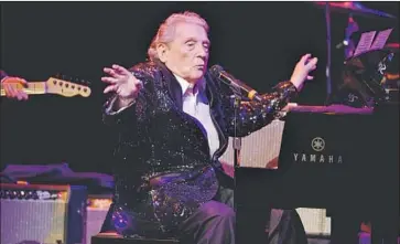  ?? Patrick T. Fallon For The Times ?? HE WINS AGAIN: Jerry Lee Lewis holds court at the piano during his performanc­e Saturday in Cerritos.