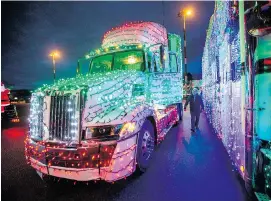  ?? DARREN STONE, TIMES COLONIST ?? The annual Truck Light Convoy and Food Drive prepares to roll at Ogden Point, the start of a circuitous route through the capital region that ended at Western Speedway on Saturday night.