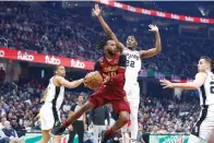  ?? (AP photo/Ron Schwane) ?? Cleveland Cavaliers guard Darius Garland (10) passes against San Antonio Spurs guard Malaki Branham (22) and forward Keldon Johnson (3) Monday during a basketball game in Cleveland.