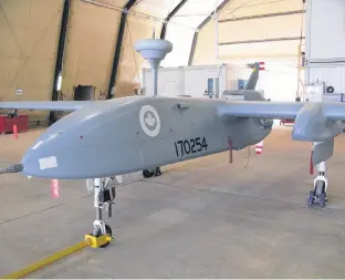  ?? BILL GRAVELAND • CP ?? A Heron pilotless spy drone, operated by the Canadian military, sits in a hangar at Kandahar Airfield on July 5, 2010.