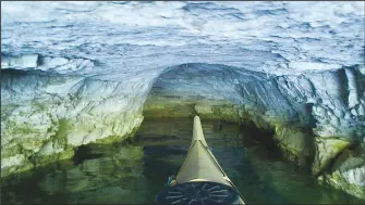  ?? (NWA Democrat-Gazette/Flip Putthoff) ?? A paddler noses his kayak into the flooded entrance of Eagle Hollow Cave in the Van Winkle Hollow arm of Beaver Lake.