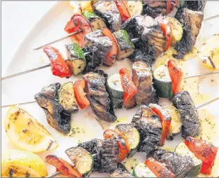  ?? AMERICA’S TEST KITCHEN VIA AP ?? Grilled vegetable kebabs with grilled lemon dressing. This recipe appears in the “The Complete Make-ahead Cookbook.”