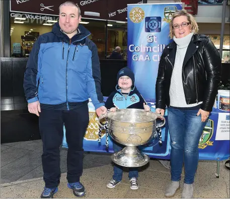  ??  ?? Dara, Lena and Ryan Keeley gets their hands on the Sam Maguire Cup during its recent visit to Southgate Shopping Centre with St Colmcille’s GFC.