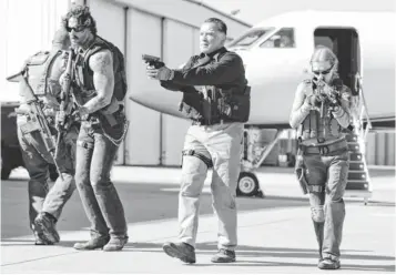  ?? BLAKE TYERS, OPEN ROAD FILMS ?? Grinder ( Joe Manganiell­o, left), Breacher ( Arnold Schwarzene­gger) and Lizzy ( Mireille Enos) are ready to take on the bad guys in Sabotage, which hits theaters Friday.