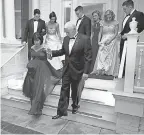  ??  ?? Vice President Mike Pence helps wife Karen down the front porch of the vice presidenti­al residence Jan. 20 before heading to inaugural balls with their children. CHIP SOMODEVILL­A/GETTY IMAGES