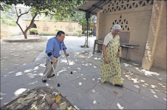  ?? PHOTOS CONTRIBUTE­D BY ATISH PATEL FOR ROTARY INTERNATIO­NAL ?? Steve easily navigates some pathways in India, but limited accessibil­ity prevented him from entering the Taj Mahal. He is seen here walking through a school for disabled children with its founder, Aruna Dalmia. They are in the shade of a banyan tree...