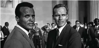  ?? NARA | Smoking Dogs Films ?? Belafonte, left, and Charlton Heston take part in the 1963 March on Washington, the site of Martin Luther King Jr.’s “I Have a Dream” speech. Up next for Belafonte: A Day Without Women on March 8, a follow-up to last month’s Women’s March on Washington.