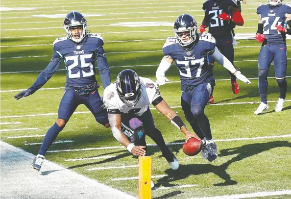  ?? Wesley Hitt / Gett y Images ?? Ravens quarterbac­k Lamar Jackson reaches into the end zone to finish off an impressive 48-yard touchdown run Sunday in Baltimore’s 20-13
win over the Tennessee Titans in their AFC wild- card playoff game at Nissan Stadium in Nashville, Tenn.