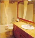  ??  ?? Bathrooms also have granite countertop­s, soaker tubs and rain showers.