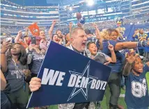  ?? JAE S. LEE/DALLAS MORNING NEWS VIA AP ?? Dallas Cowboys fans, including Terry Cox who holds a sign, cheer when the Cowboys select Bo Scarbrough in the seventh round at the NFL Draft in AT&T Stadium in Arlington, Texas on Saturday.