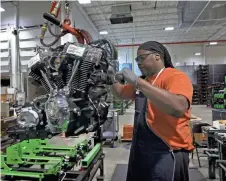  ?? / MILWAUKEE JOURNAL SENTINEL ?? Michael Guster inspects and readies a new Harley-Davidson Milwaukee-Eight engine at the Pilgrim Road engine plant.
