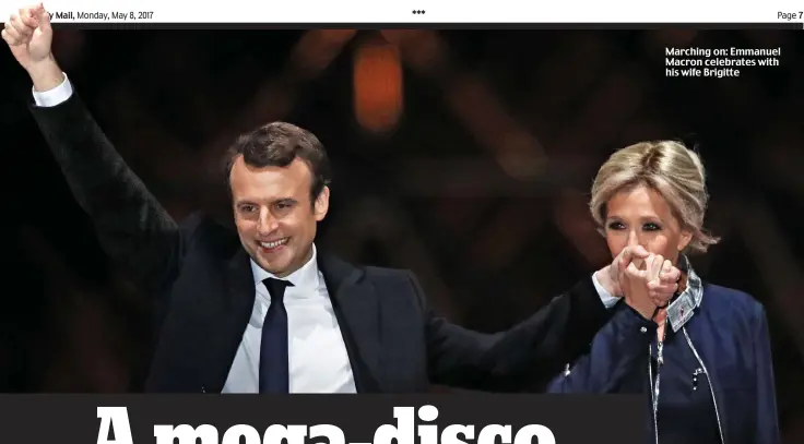  ??  ?? Marching on: Emmanuel Macron celebrates with his wife Brigitte