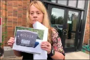  ?? (AP /Stephen Groves) ?? Standing outside the courthouse Thursday in Fort Pierre, S.D., Jane Boever holds a photo of the tombstone of her brother, Joseph Boever, who was struck and killed last year by Attorney General Jason Ravnsborg. Jane Boever said Ravnsborg’s punishment was “a slap on the wrist.”