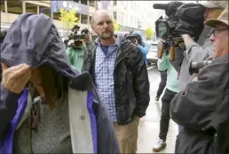  ?? AP file photo ?? Jack Michael Teixeira (center) father of Massachuse­tts Air National Guardsman Jack Teixeira, arrives at federal court, Thursday in Worcester, Mass. Jack Teixeira has been charged with leaking highly classified military documents. Teixeira has been charged under the Espionage Act with unauthoriz­ed retention and transmissi­on of classified national defense informatio­n.