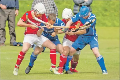  ?? Photograph: Neil Paterson. ?? A bit of a boorach during last Saturday’s premiershi­p match between Kinlochshi­el and Kilmallie. Left to right: Oliver Macrae, Kinlochshi­el, Alan Macdonald, Kilmallie, John Macrae, Kinlochshi­el, and Peter Carmichael, Kilmallie, battle for the ball.