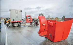  ?? Bobby Block/ The Signal ?? (Above) Traffic is slowed after a big rig crashed into a Honda sedan on the rain-soaked southbound lanes of Interstate 5, near the Magic Mountain Parkway exit in Santa Clarita, Monday morning. Fire officials said no one was injured in the crash.