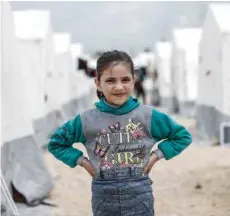  ?? — AFP ?? A Syrian girl looks at a camp for displaced Syrians in Al-bil, east of the rebel-held town of Azaz in northern Syria, on Sunday.