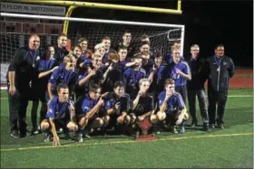  ?? CHRIS DEANTONIO - FOR DIGITAL FIRST MEDIA ?? The Oley Valley boys soccer team celebrates with the BCIAA trophy after winning the championsh­ip over Wilson, 2-1, on Oct. 20.