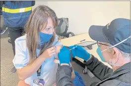  ?? TERRY CHEA — THE ASSOCIATED PRESS FILE ?? Grace John, who works at a school in San Lorenzo, gets a COVID-19 shot at a mobile vaccinatio­n clinic in Hayward.