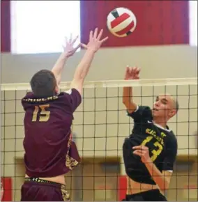  ?? JOHN BREWER - ONEIDA DAILY DISPATCH ?? Canastota’s Sam Snow attempts to block a shot by Spencer Sundeen, of Voohreesvi­lle, during boys volleyball regional play on Saturday, March 3.