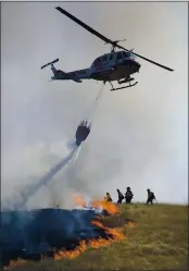  ?? KENT PORTER — THE PRESS DEMOCRAT ?? A Cal Fire crew from Cobb Mountain assists in putting out a 12-acre brush fire in Larkfield on Thursday.