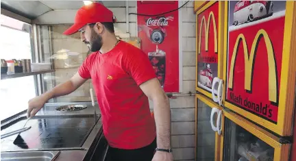  ?? PHOTOS: VAHID SALEMI/THE ASSOCIATED PRESS ?? A knock-off version of McDonald’s — Mash Donald’s — exists in Tehran, selling burgers and fries, and its owner welcomes potential competitio­n from McDonald’s. Under the recent nuclear deal, businesses are looking at Iran as a major market.