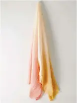  ??  ?? PINK SHERBET
Summer calls for lightweigh­t layers you can throw in your bag, ready to pull out at dusk or if the sky suddenly clouds over. This hand-dyed, ombré rectangula­r scarf by Auxiliary is made from 100 per cent washed linen and features a natural, oh-so-touchable texture that somehow just gets better with wear.
Aritzia, aritzia.com | $48