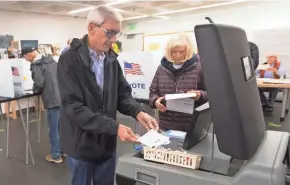  ?? MARK HOFFMAN / MILWAUKEE JOURNAL SENTINEL ?? Democratic candidate for governor Tony Evers and his wife, Kathy, vote Tuesday at the central branch of the Madison Public Library, 201 W. Mifflin St.
