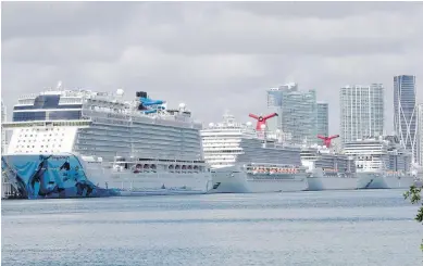  ??  ?? Cruise ships are docked at Port of Miami on Tuesday. The U.S. Coast Guard said that it’s working with Holland America on a detailed plan to handle all medical issues on two stranded cruise ships.