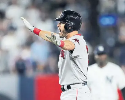  ?? ELSA GETTY IMAGES ?? Boston’s Ian Kinsler, back at second base after Game 3 hero Brock Holt gave him a day off Monday, celebrates a third-inning RBI double. The Red Sox beat the Yankees 4-3 to win their division series in four games. Full coverage at thestar.com.