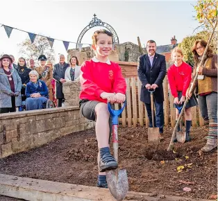  ?? ?? Children from Widcombe Junior School planting a pear tree with help from from Bath & North East Somerset Council leader Councillor Kevin Guy and outdoor play champion Zosia Brett