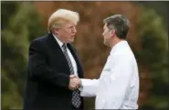 ?? CAROLYN KASTER - THE ASSOCIATED PRESS ?? President Donald Trump shakes hands with White House physician Dr. Ronny Jackson as he boards Marine One as he leaves Walter Reed National Military Medical Center in Bethesda, Md., Friday, Jan. 12, 2018, after his first medical check-up as president.
