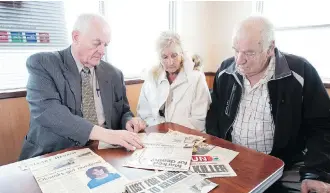  ?? GAVIN YOUNG ?? Former Reform and Conservati­ve MP Art Hanger, left, sits with Darlene and Doug Boyd as they go through old newspaper clippings Monday. The Boyds’ daughter Laurie was abducted and murdered in 1982.