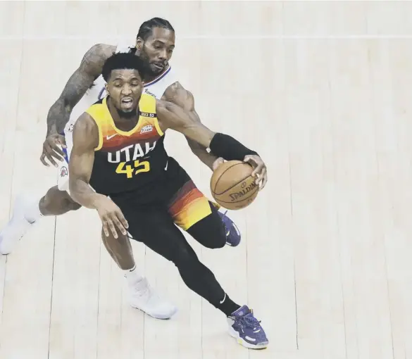  ??  ?? 0 In-form talisman Donovan Mitchell of the Utah Jazz drives in front of LA Clippers’ Kawhi Leonard in a closely-fought Western Conference play-off series.