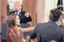  ?? EVAN VUCCI/ASSOCIATED PRESS ?? President Donald Trump berates CNN’s Jim Acosta as a White House aide tries to take a microphone away from the reporter.